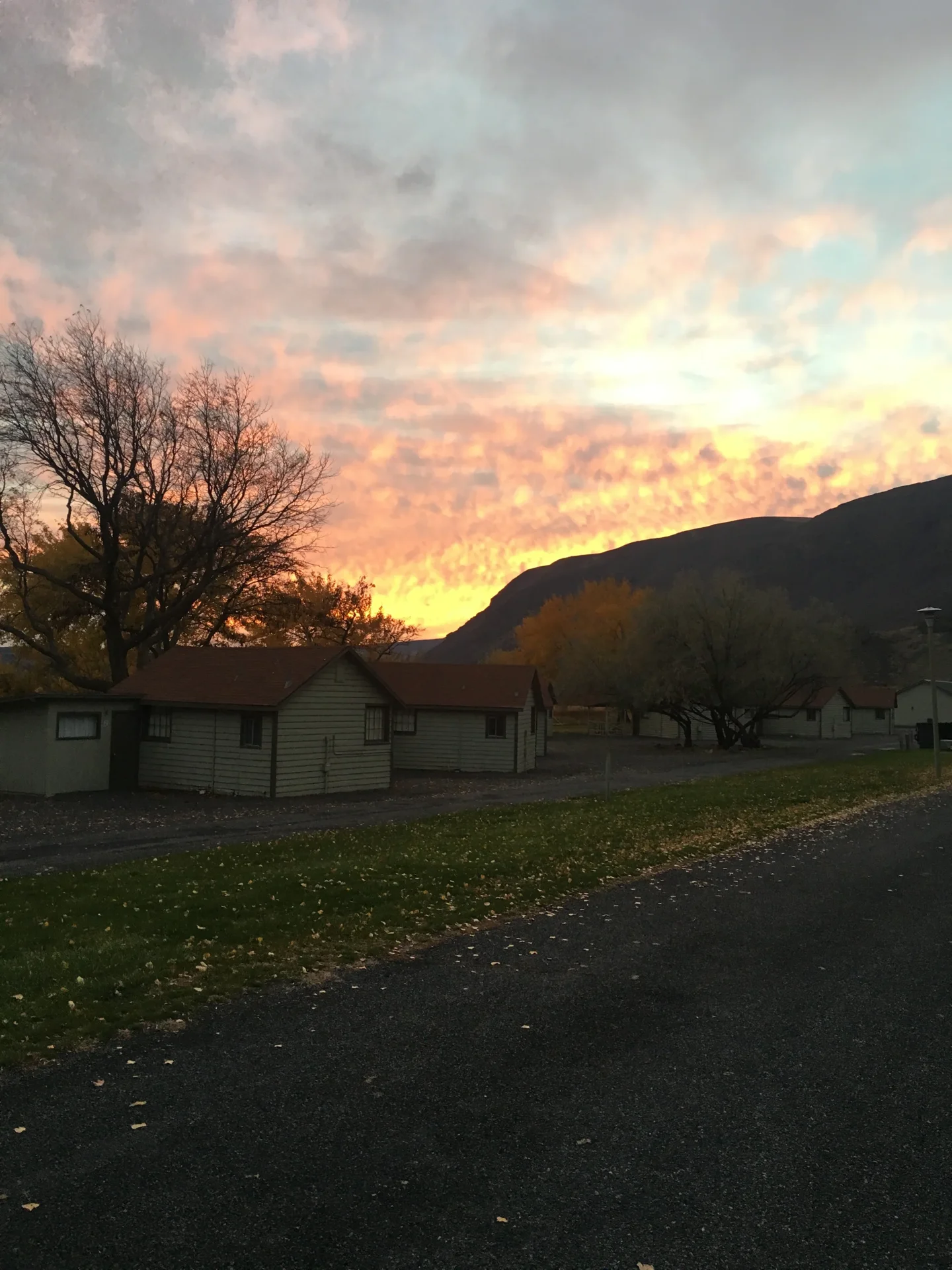 Fiery sunset over lakeside cabins